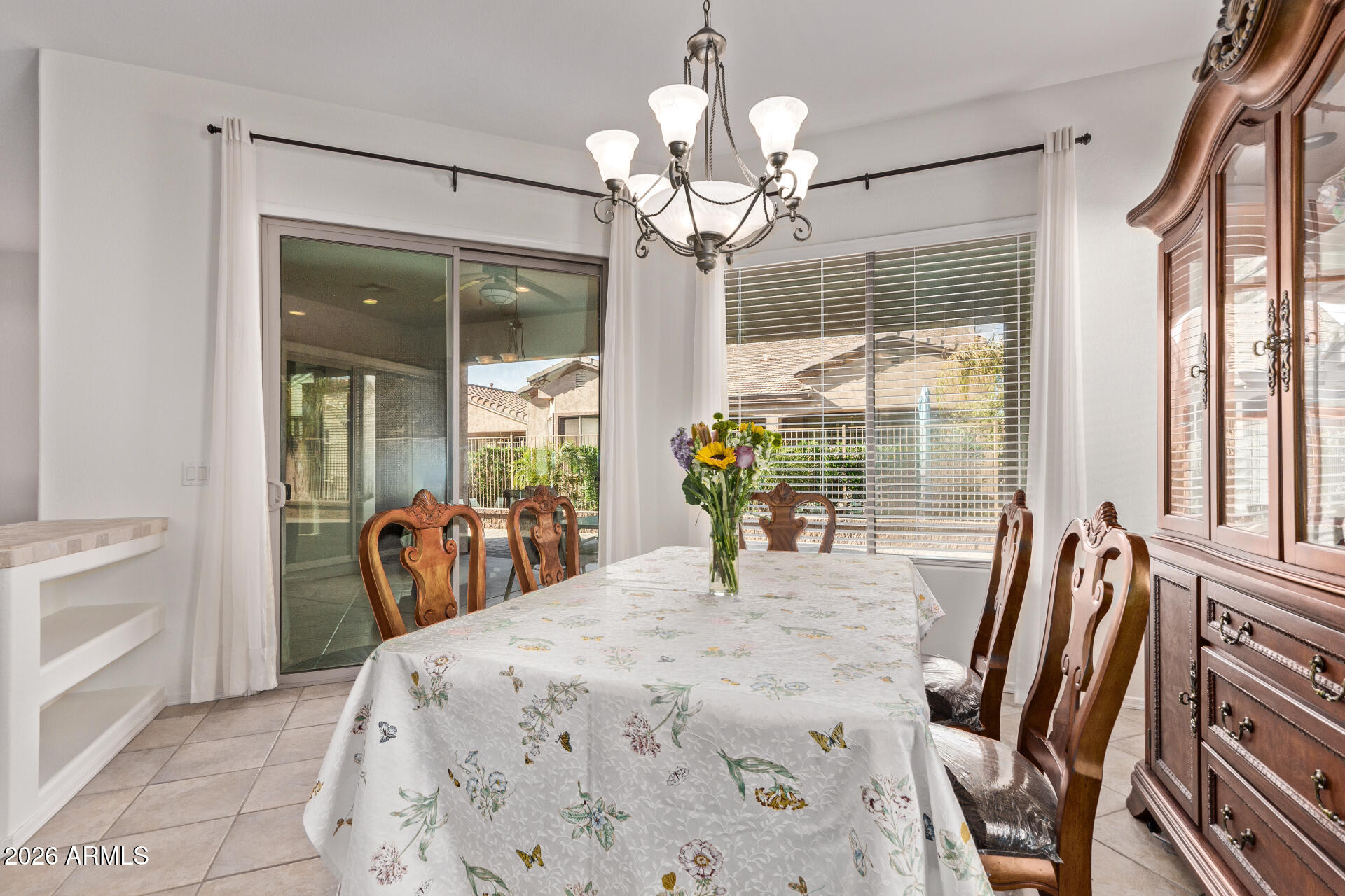 4120 East Jude Lane Gilbert, AZ 85298 - Photo 10 of 61 a view of a dining room with furniture wooden floor and chandelier