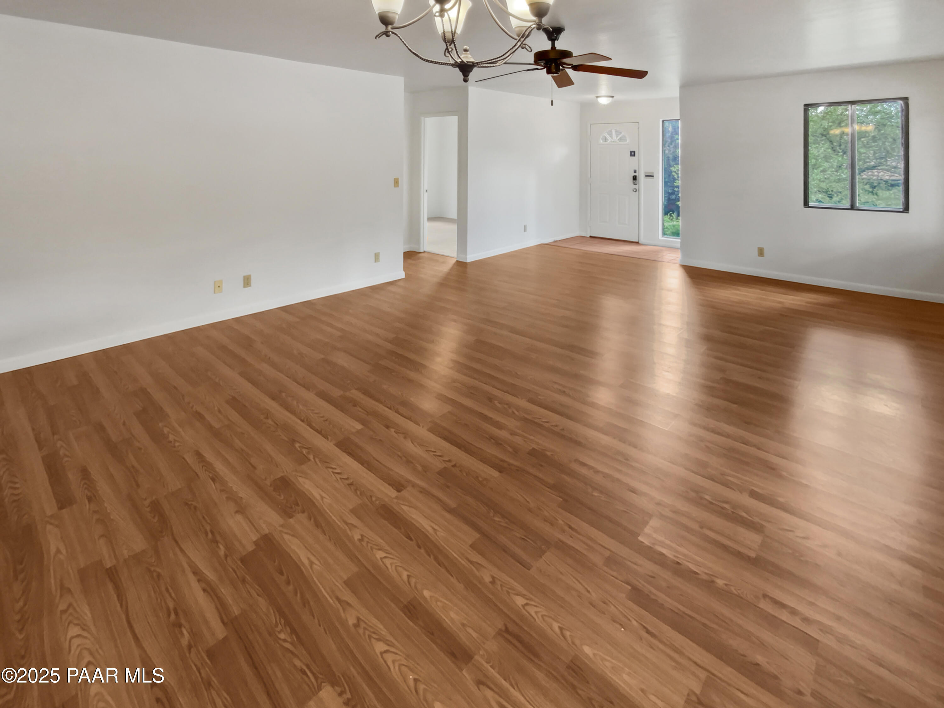 410 Apache Plume Trail Prescott, AZ 86301 - Photo 11 of 22 an empty room with wooden floor a ceiling fan and windows