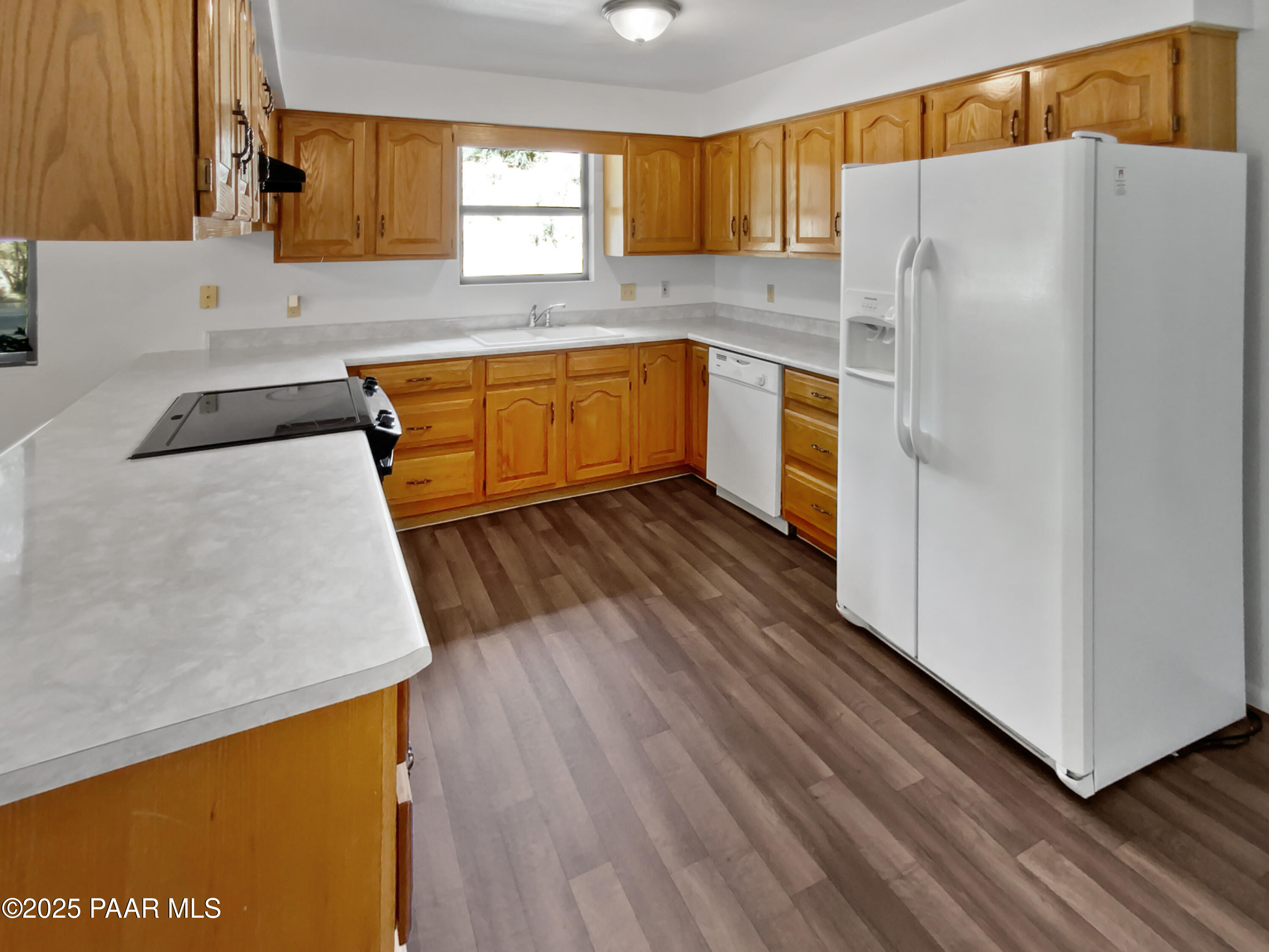 410 Apache Plume Trail Prescott, AZ 86301 - Photo 13 of 22 a kitchen with wooden floors and white appliances