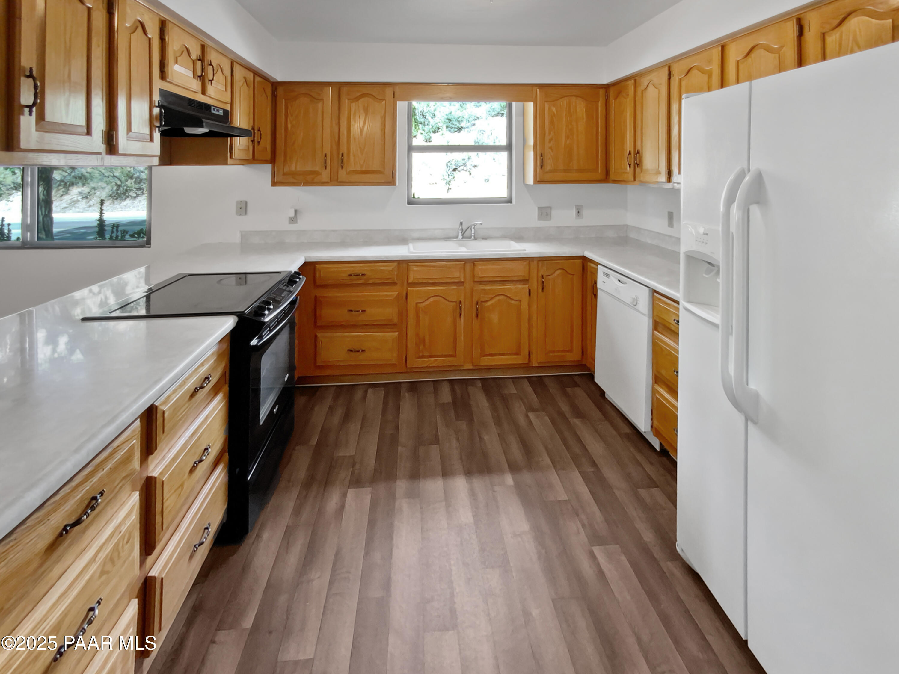 410 Apache Plume Trail Prescott, AZ 86301 - Photo 2 of 22 a kitchen with granite countertop a sink a counter space stainless steel appliances and cabinets