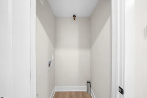 a bedroom with a large bed and a chandelier fan