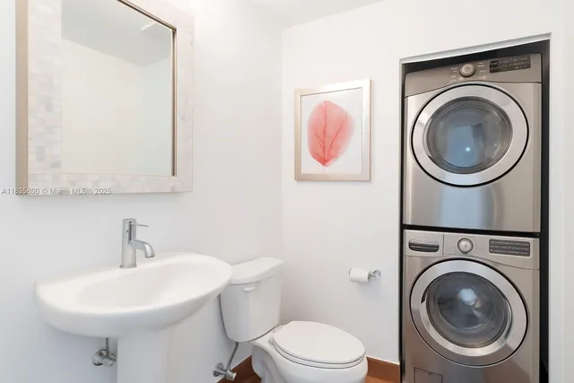 a bathroom with a sink mirror and toilet