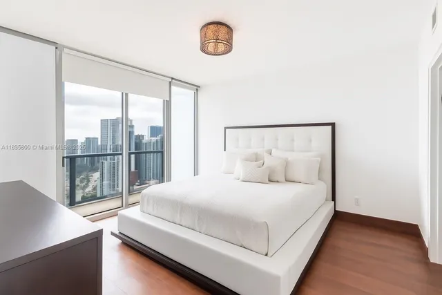 a bedroom with a large bed and a window