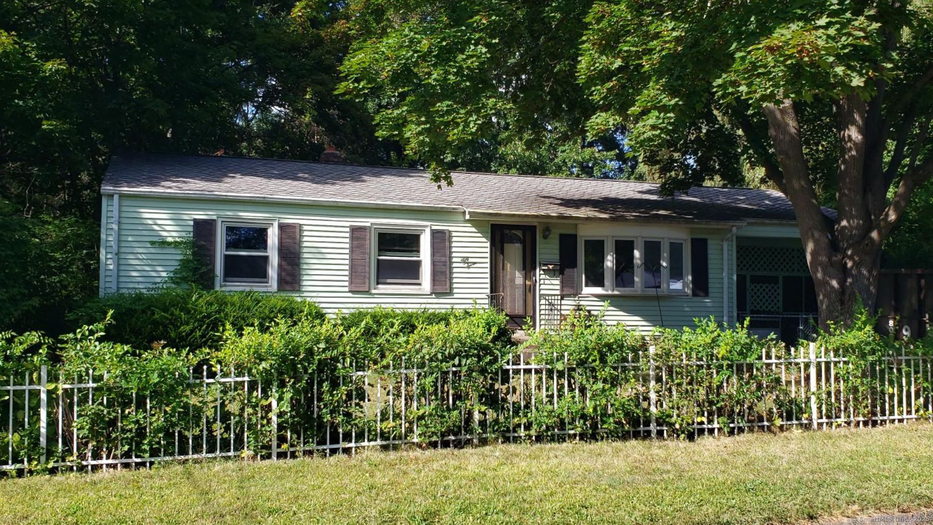 front view of a house with a garden