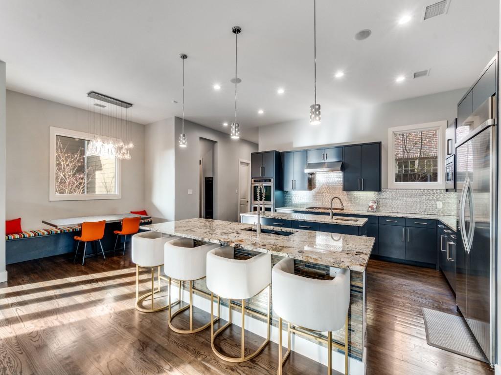 7912 Hanover Street Dallas, TX 75225 - Photo 9 of 25 Kitchen with light stone counters, dark wood-style floors, hanging light fixtures, and plenty of natural light