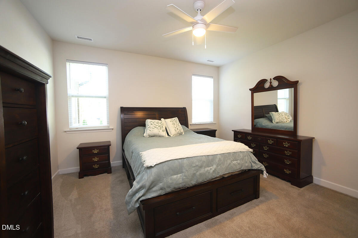 125 Mae Court Roxboro, NC 27573 - Photo 17 of 30 a bedroom with a bed and a tv on the dresser