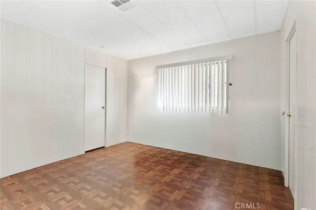 a view of a kitchen with wooden floor and a window