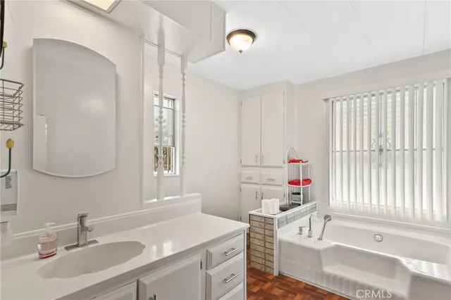 a bathroom with a sink vanity and a mirror