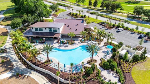 an aerial view of a house swimming pool and patio