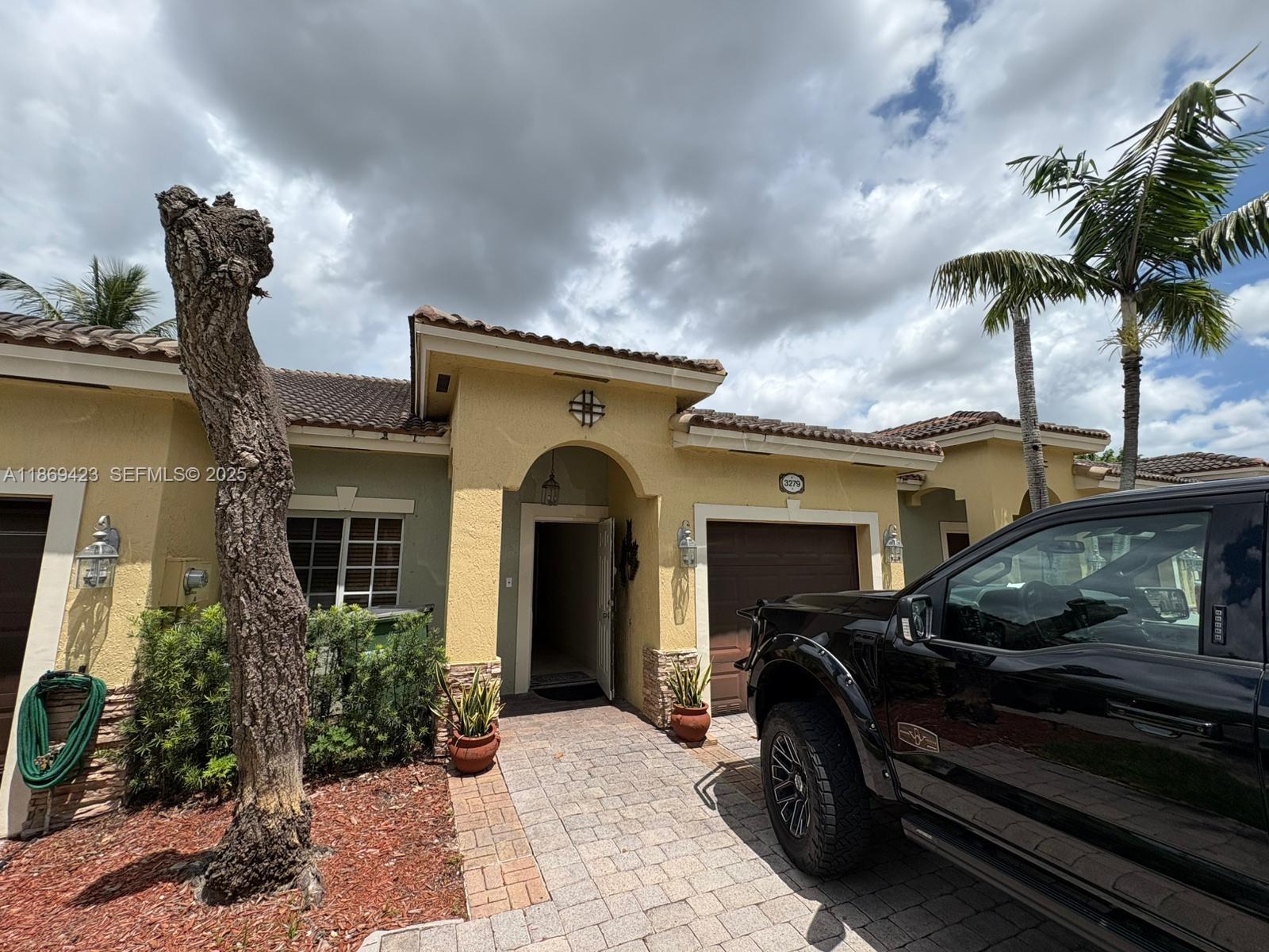 a front view of a house with garden