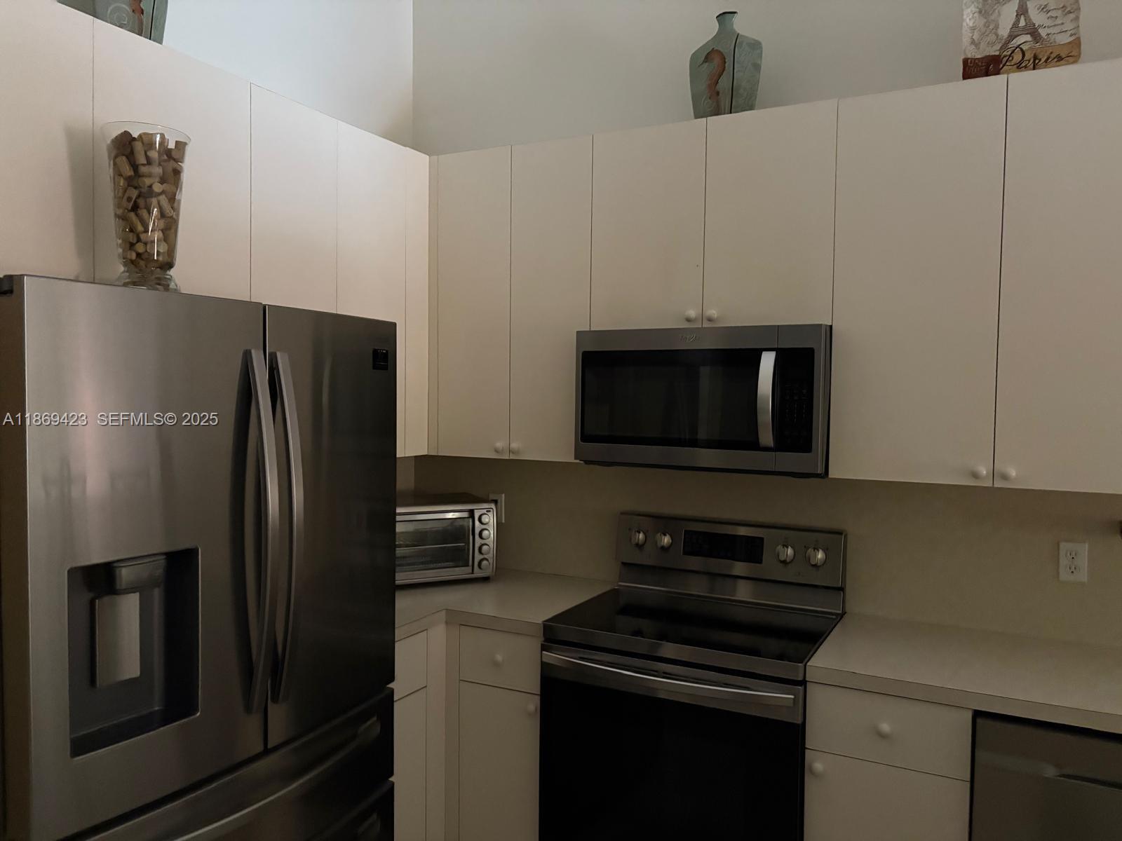 3279 Northeast 11th Drive Homestead, FL 33033 - Photo 2 of 15 a kitchen with a refrigerator stove and microwave