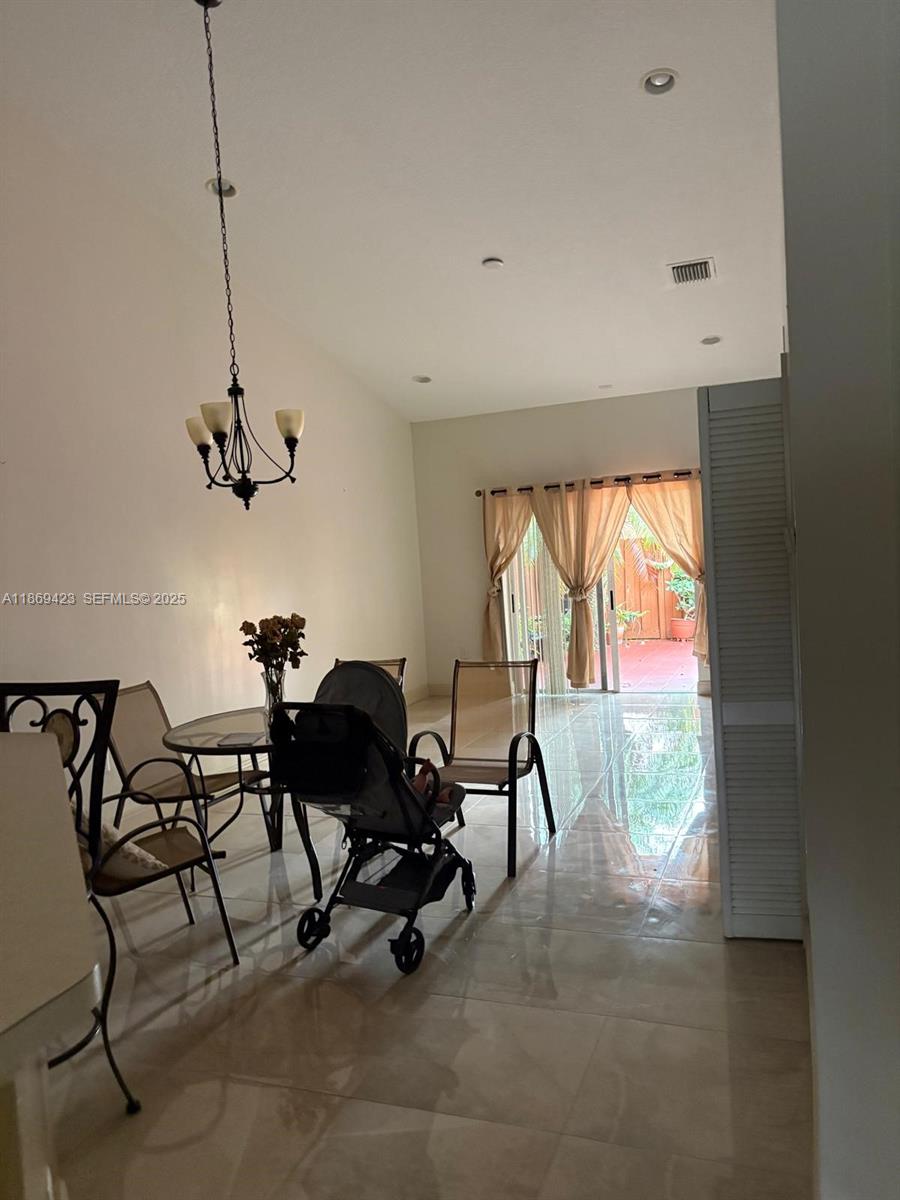 3279 Northeast 11th Drive Homestead, FL 33033 - Photo 4 of 15 a view of a workspace with furniture and a window
