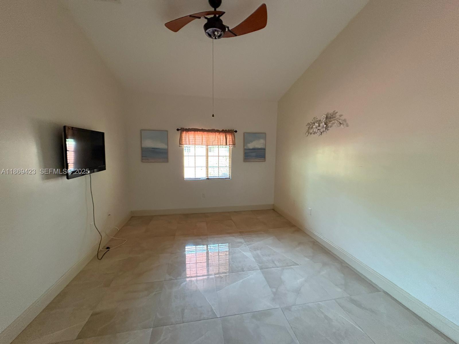 3279 Northeast 11th Drive Homestead, FL 33033 - Photo 9 of 15 a view of a livingroom with an empty space and a window