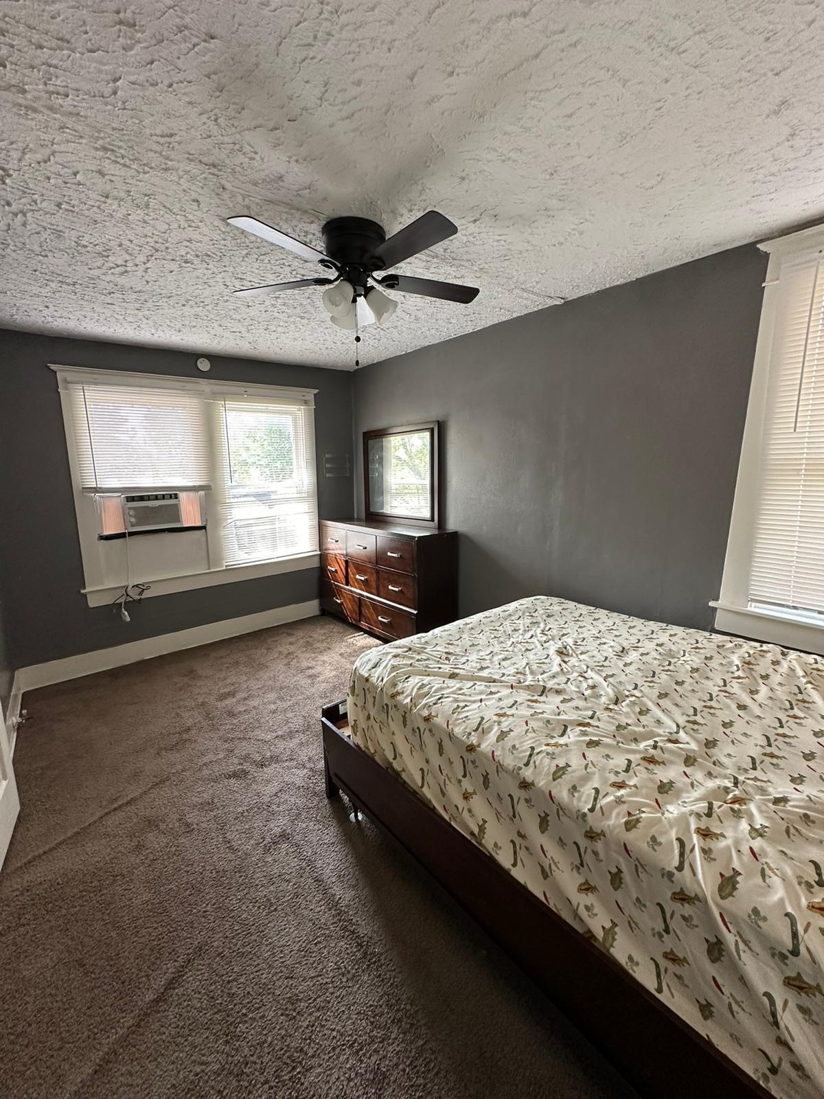 6818 Stearns Street Houston, TX 77021 - Photo 13 of 18 a bed sitting in a spacious bedroom next to a window