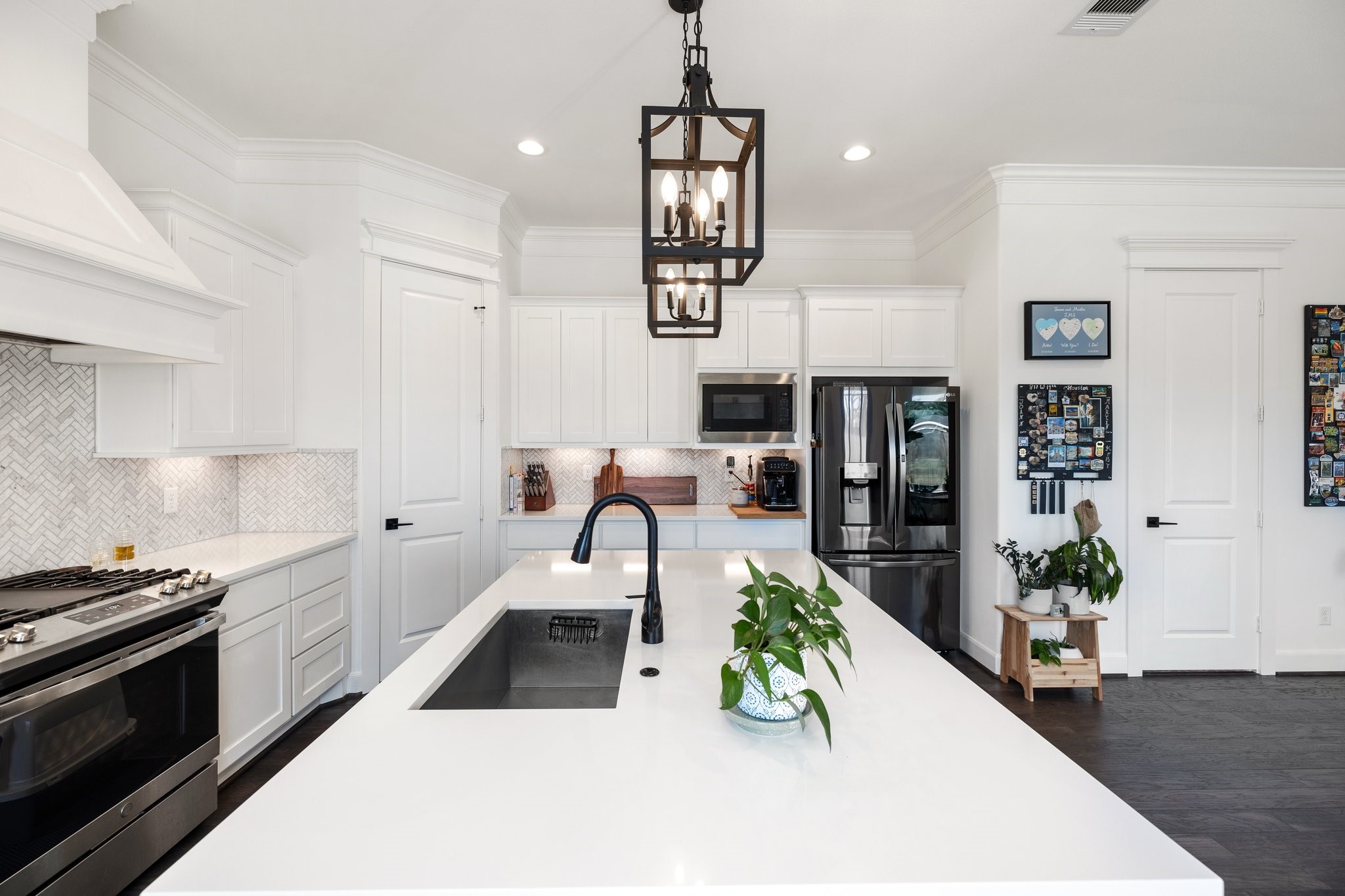 817 West 19th Street Houston, TX 77008 - Photo 6 of 24 a kitchen with stainless steel appliances kitchen island granite countertop a stove a sink and a white cabinets