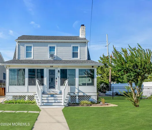 a front view of a house with a garden and plants