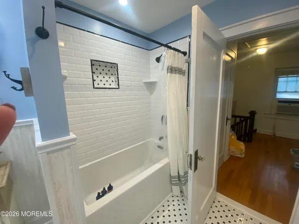 a bathroom with a tub a sink and a shower