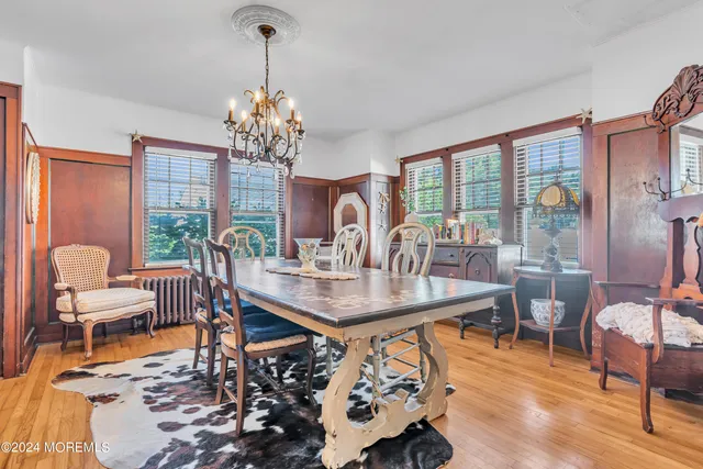 a view of a dining room with furniture wooden floor and chandelier