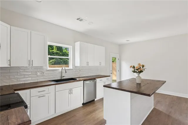 a kitchen view white cabinets and a refrigerator