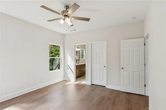a view of a livingroom with a ceiling fan and wooden floor