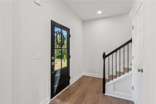 a view of an entryway with wooden floor