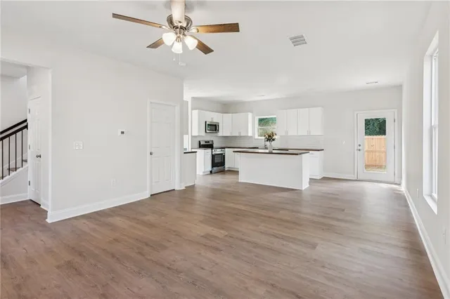 a view of a kitchen with a sink a refrigerator and a window