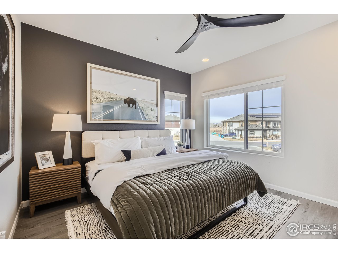 1002 Collamer Drive, Unit 8 Fort Collins, CO 80524 - Photo 22 of 39 a bedroom with a bed a window and a painting on the wall