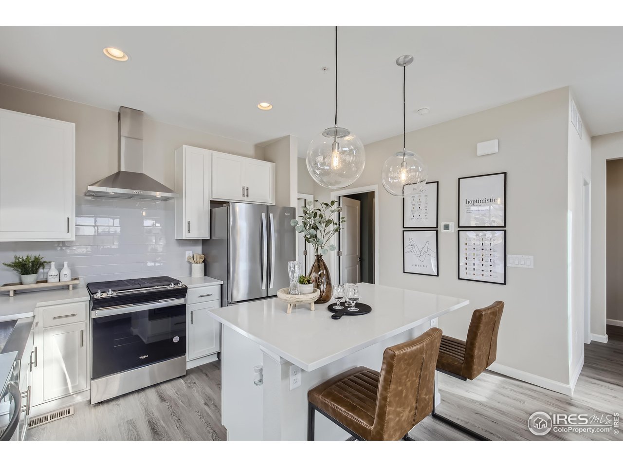1002 Collamer Drive, Unit 8 Fort Collins, CO 80524 - Photo 13 of 39 a kitchen with stainless steel appliances kitchen island granite countertop a sink a stove a refrigerator and white cabinets
