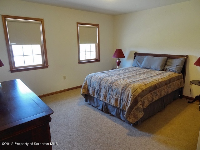 15 North Legend Road Shavertown, PA 18708 - Photo 14 of 23 a bedroom with a bed lamp and window