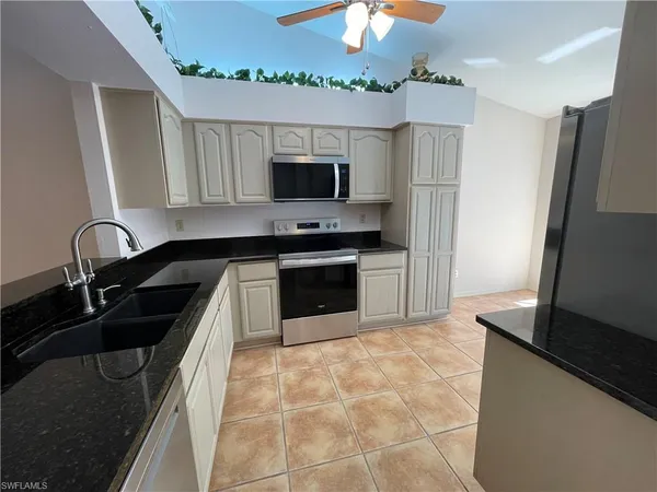 a kitchen with a sink a stove and a refrigerator