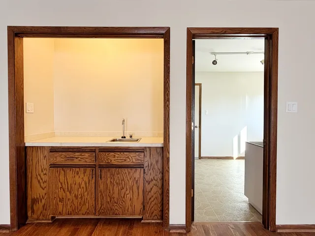 a view of a kitchen from a hallway