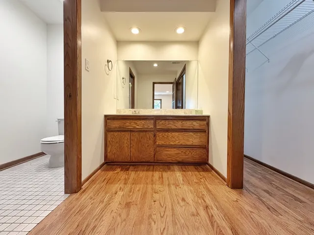 a view of a room with wooden floor and cabinet