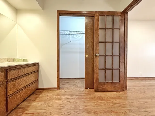 a view of walk in closet with empty racks
