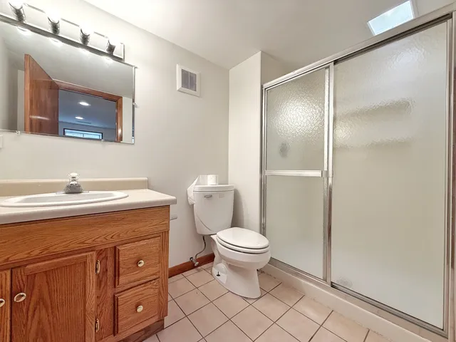 a bathroom with a sink toilet and a mirror