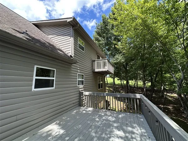 a view of house with backyard and sitting area