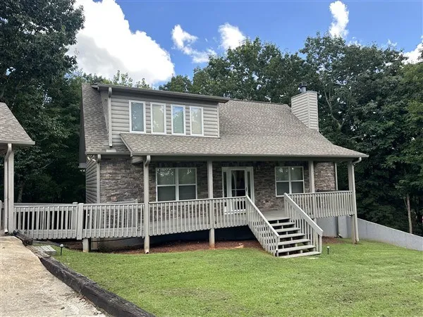a front view of a house with a garden