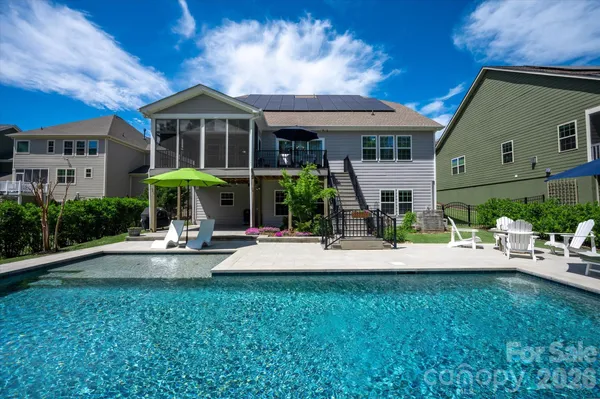 a view of a house with backyard sitting area and garden
