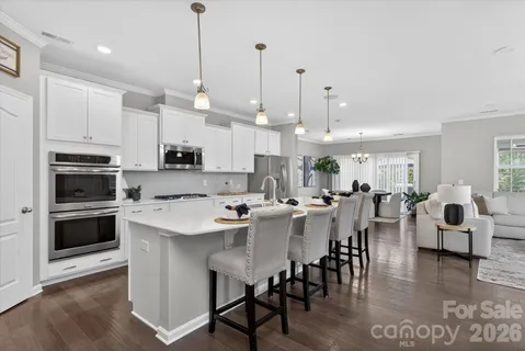 a large kitchen with a table and chairs