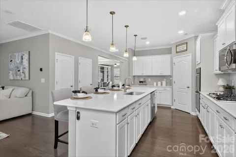 a large kitchen with kitchen island a sink a center island a stove and a center island