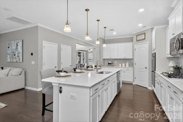 a large kitchen with kitchen island a sink a center island a stove and a center island