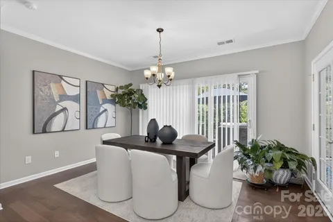 a dining room with furniture and potted plant