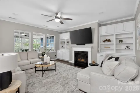 a living room with furniture a fireplace and a flat screen tv