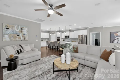 a living room with furniture or kitchen view and a chandelier