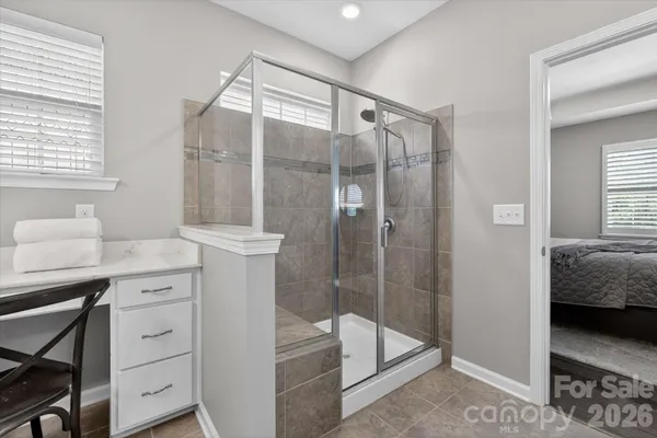 a bathroom with a shower sink and mirror