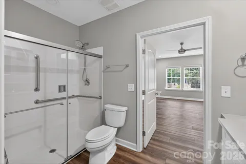 a bathroom with a toilet and a shower