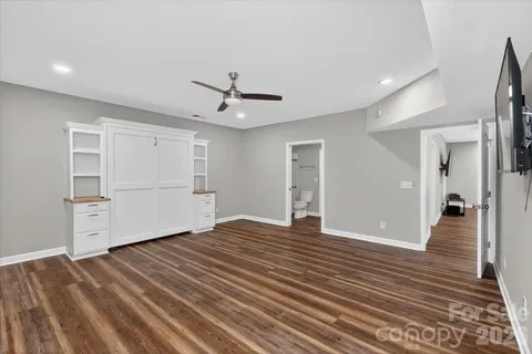 a view of an empty room with closet and a window