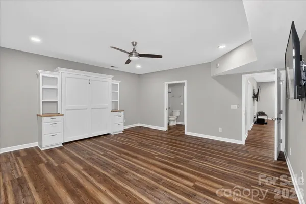 a view of an empty room with closet and a window