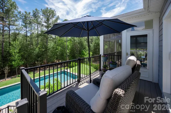 a balcony with wooden floor and furniture