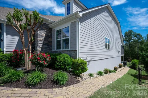 a house with a flower garden in front of it