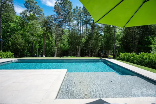 a view of a swimming pool with a yard